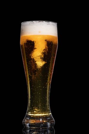 Glass of beer isolated on black background.の写真素材