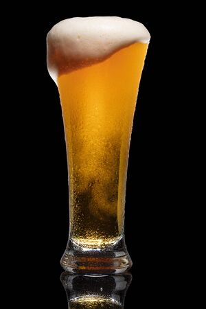 Glass of beer isolated on black background.の写真素材