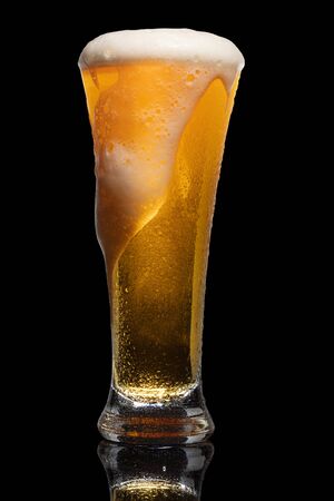 Glass of beer isolated on black background.の写真素材