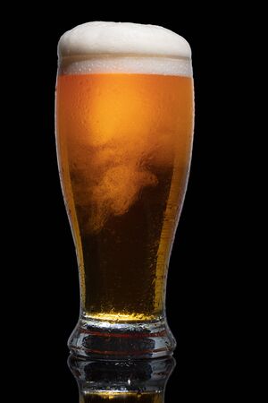 Glass of beer isolated on black background.の写真素材