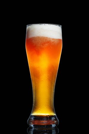 Glass of beer isolated on black background.の写真素材