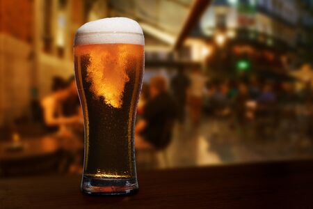 glass of beer on a street bar tableの写真素材