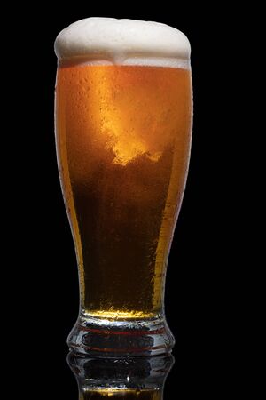 Glass of beer isolated on black background.の写真素材