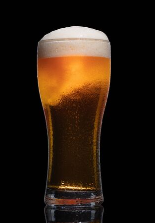 Glass of beer isolated on black background.の写真素材