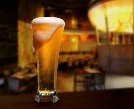 cold glass with beer on the background of bar.の写真素材