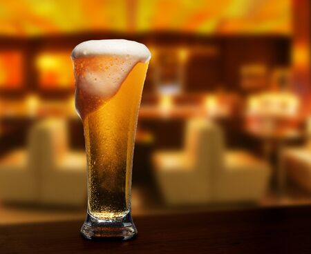 glass of beer on a street bar tableの写真素材