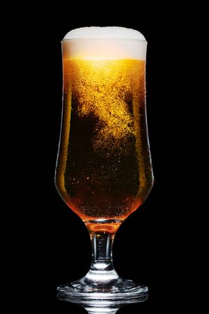 Glass of beer isolated on black background.の写真素材
