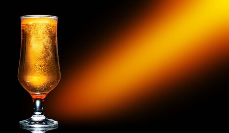 Glass of cold craft light beer on dark background.
の写真素材