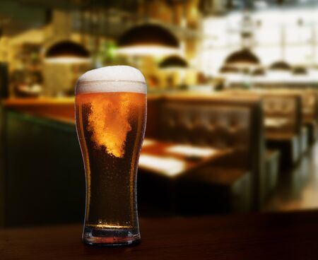 cold glass with beer on the background of bar.の写真素材