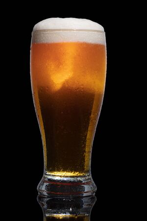 Glass of beer isolated on black background.の写真素材