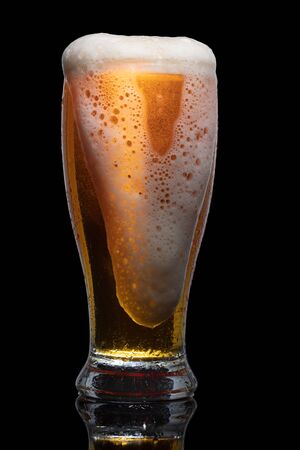Glass of beer isolated on black background.の写真素材