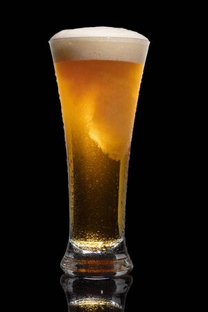 Glass of beer isolated on black background.の写真素材