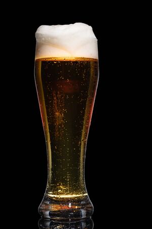 Glass of beer isolated on black background.の写真素材