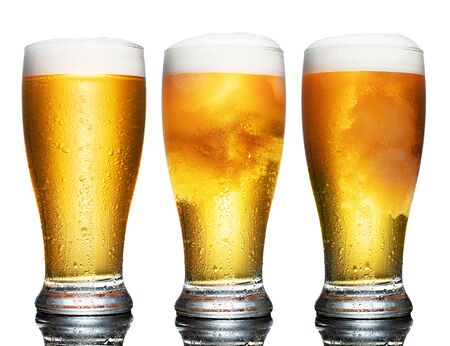 Set of a glass of cold light beer with foam isolated on white backgroundの写真素材