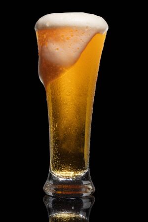 Glass of beer isolated on black background.の写真素材
