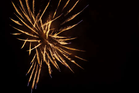 Golden orange amazing fireworks isolated in dark backgroundの写真素材