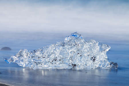 Jokulsarlon Ice in morning sun lights on sea beach, Iceland,