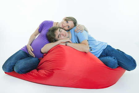 Portrait of young pair pending the kid isolated on white backgroundの写真素材