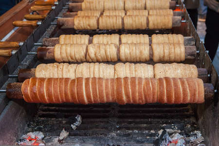 Cooking trdelnik also known as Trdlo is a czech traditional sweet pastryの写真素材