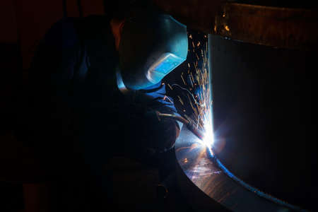 Welder worker is welding a big valve  body