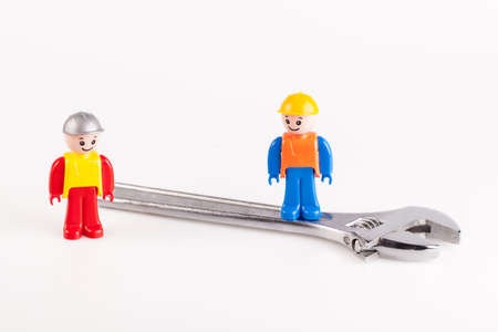 Miniatures of construction workers isolated on white backgroundの写真素材