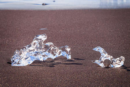 Jokulsarlon Ice in morning sun lights on sea beach, Iceland,