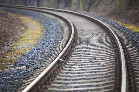 Railway track leading into the unknown through a forestの写真素材