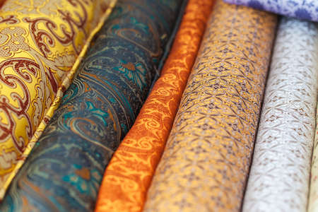 Rolls of fabric and textiles in a factory shop. Multi different colors and patterns on the marketの写真素材