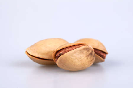 three fresh and dry almonds on white backgroundの写真素材