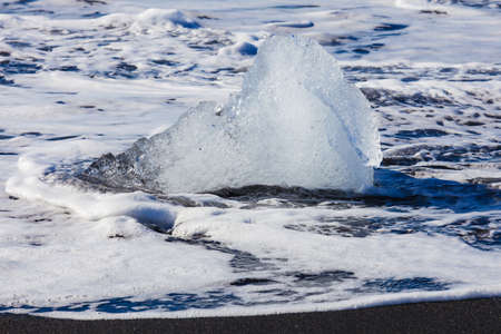 Jokulsarlon Ice in morning sun lights on sea beach, Iceland,