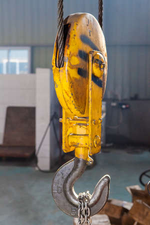 Metallic industrial hook for lifting heavy thing in the factoryの写真素材