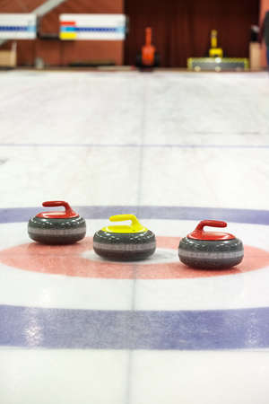 A two curling stone on the ice of a curling rinkの写真素材