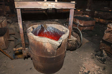 Molten metal. Left over material from the steel manufacturing process is poured away on at a Steel...