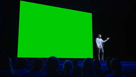 Software Startup Founder Does Presentation of New Product to the Audience, Behind Him Movie Theater...