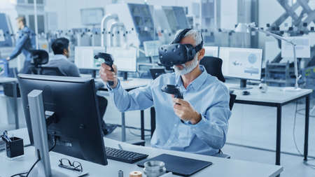 Industrial Design Engineer Wearing Virtual Reality Headset and Holding Controllers, Uses VR...