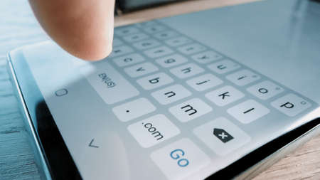 Close-up Macro POV Shot: Person Using Touch Screen Smartphone Device and Typing Message. Concept of Email Writing, Chatting in Social Media Apps, Sending an SMS, Taking Noteの写真素材