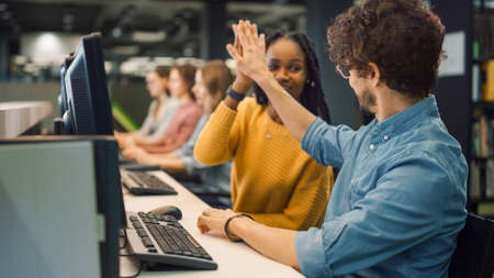 Bright Black Girl and Smart Hispanic Boy Together Work on Computers, Give High-Five After...