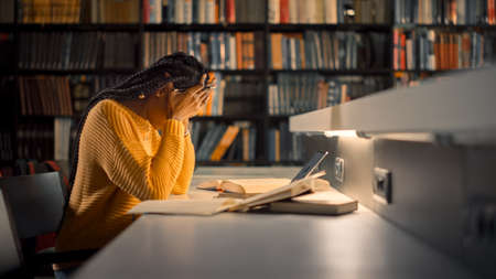 University Library: Exhausted and Tired Black Girl uses Laptop, Writes Essay, Study for Class...