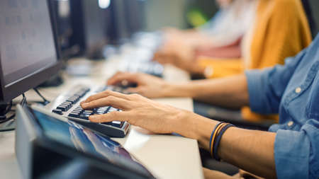 Row of Diverse Group of Multi-Ethnic People Works on PC. Office Team of Technical Support Staff Members Work on Computers, Help People Find Solutions. Camera Shot focus On Handsの写真素材