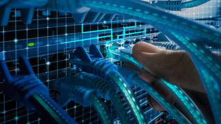 Macro Shot with Augmented Reality: IT Administrator Plugs in RJ45 Internet Connector into LAN Router...