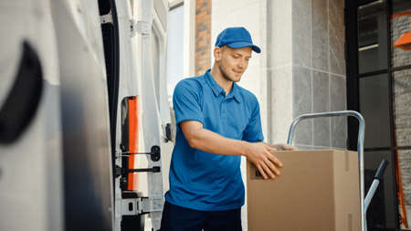 Delivery Man Uses Hand Truck Trolley Full of Cardboard Boxes and Packages, Loads Parcels into Truck...