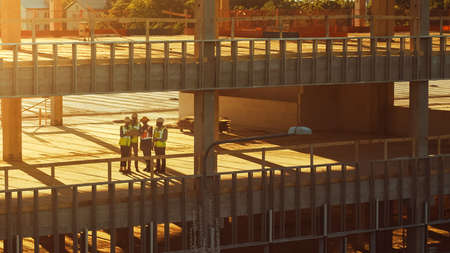 Aerial View: Diverse Team of Specialists Inspect Commercial, Industrial Building Skyscraper Formwork...