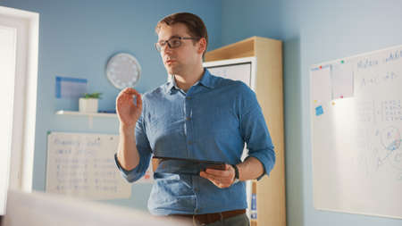 School Class: Portrait of the Enthusiastic and Motivated Teacher Using Digital Tablet Computer,...