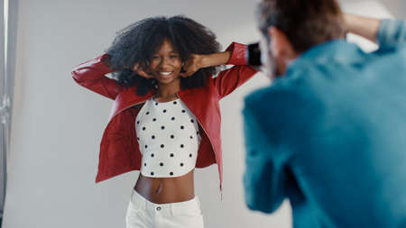 Attractive Black Girl with Lush Curly Hair Posing for a Fashion Magazine Photoshoot. Beautiful Girl...