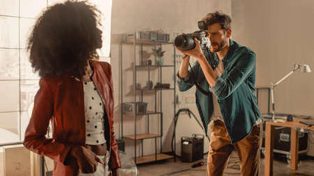Beautiful Black Model Posing for a Photographer, he Takes Pictures with Professional Camera. She...