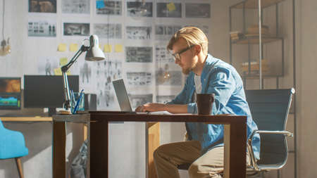 Creative Developer Works on a Laptop in His Studio. Designing Apps, Games and Doing Video Editing....