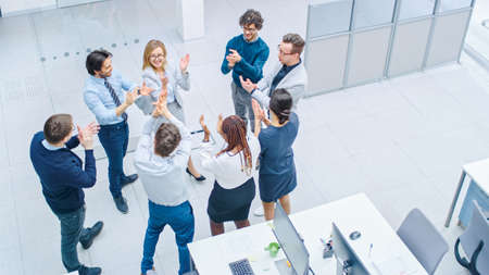 Eight Successful Office Workers doing Team Building Exercise and Applauding Together in the Unifying...