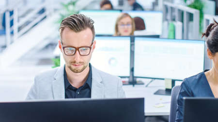 Big Busy Corporate Office with Two Rows off Businessmen and Businesswomen Working on Desktop...