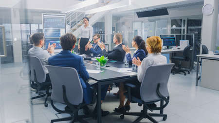 In the Corporate Meeting Room: Female Executive Uses Digital Interactive Whiteboard for Presentation...