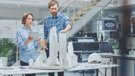 In Architectural Bureau: Architect and Engineer Talking, Working on a Building Complex Prototype...